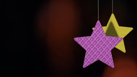 christmas star ornaments are swinging on bokeh background loopable file