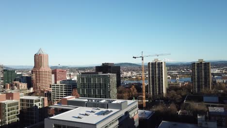 an aerial view of downtown portland  with mount hood in the background.