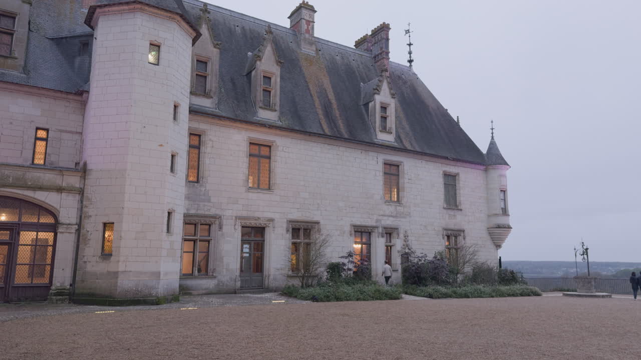 Man walks on courtyard of castle at Chaumont-sur-Loire in France, slow pan