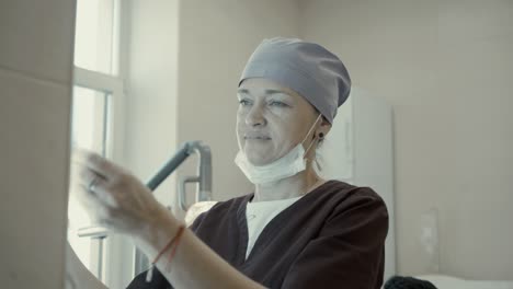 woman dentist looking xray jaw