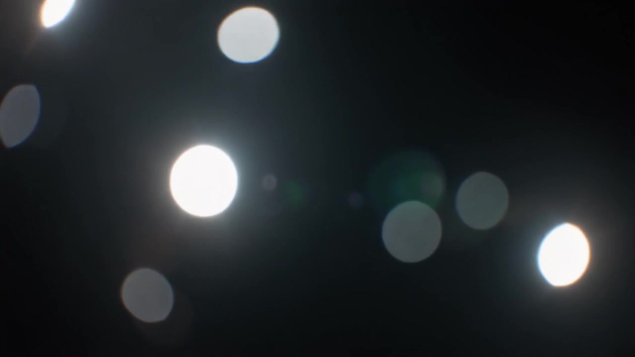 Abstract Bokeh Lights Moving Against a Dark Background