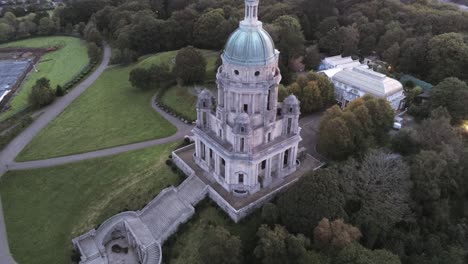 Ashton-memorial-landmark-staircase-Lancashire-countryside-park-gardens-sunrise-Aerial-rising-tilt-down-view