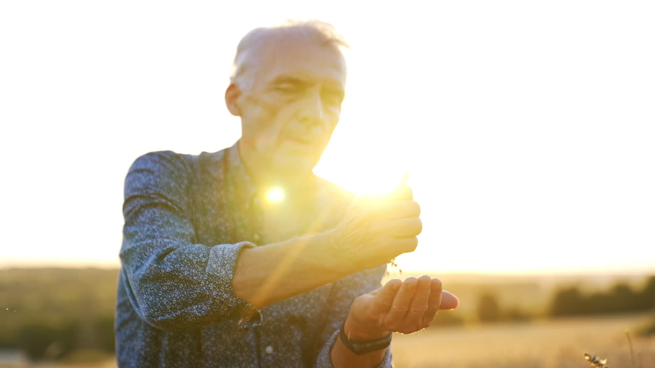 Elderly man enjoying sunset in nature. An elderly man reflects on life while sitting outdoors at sunset, surrounded by beautiful natural scenery