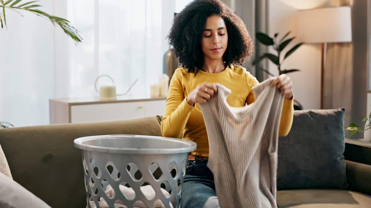 Woman folding laundry at home