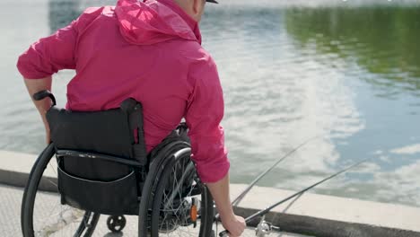 person with a physical disability who uses wheelchair fishing from fishing pier