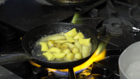 fresh agnolotti pasta in frying pan with parsnips and potatoes closeup shot