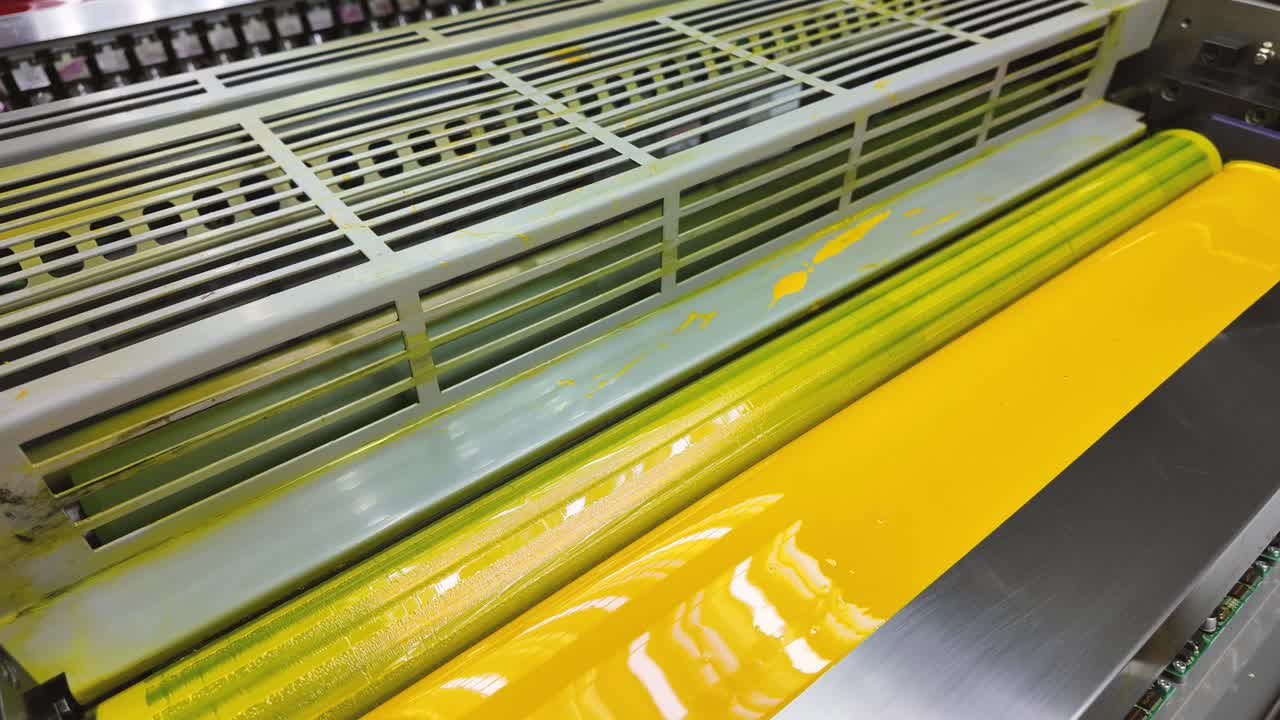Offset printing press. Lithographic press with yellow ink dispenser.