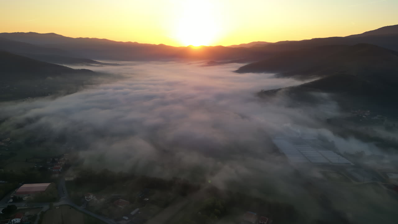 Aerial drone view of clouds above Castiglion Fiorentino in eastern Tuscany, Italy at sunrise
