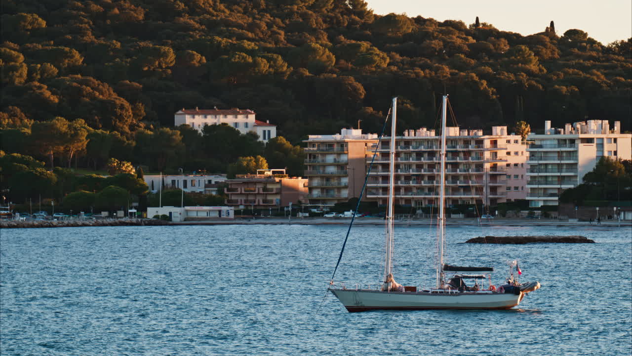 Juan-les-Pins, France - January 25, 2025: Small boat floating on the sea at sunset