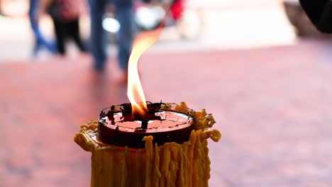 person lighting a candle in ayutthaya