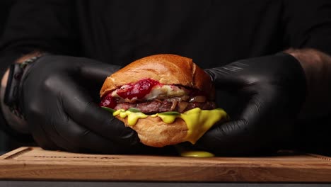 chef holding a gourmet burger