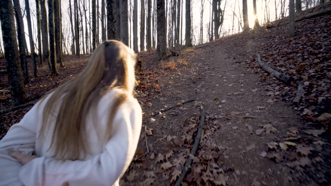 Woman hiking on a trail in the woods