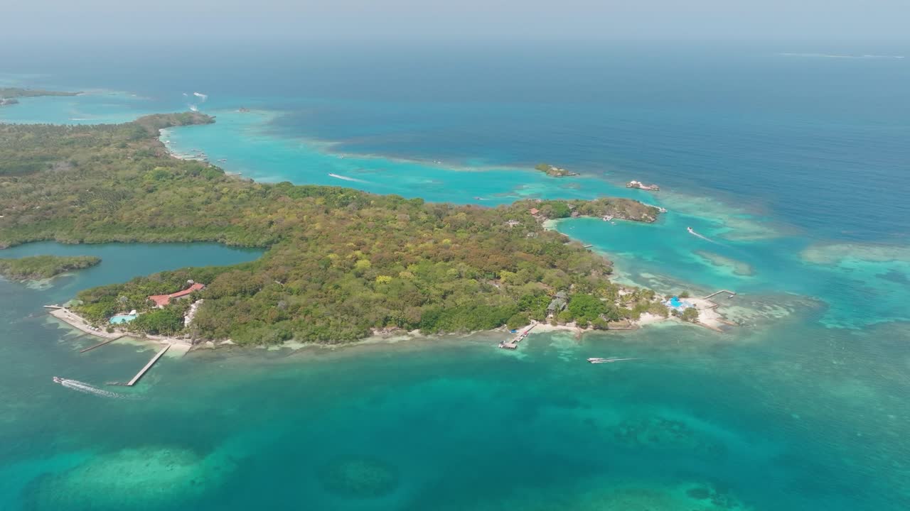 Drone view of Isla Grande in Rosario Islands, Colombia, surrounded by crystal clear Caribbean waters, coral reefs and lush tropical scenery