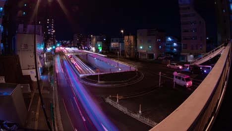 a night timelapse of the traffic jam at the city street in tokyo fish-eye shot