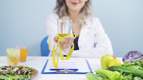 Dietitian-doctor-handing-fruit-to-camera.