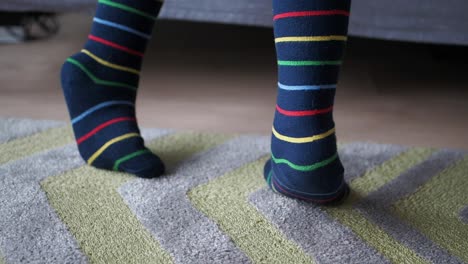 close-up of colorful striped socks on a rug