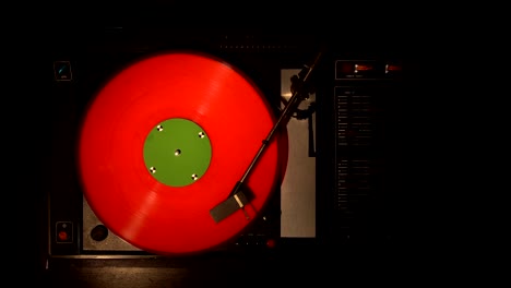 vinyl record pleer. plays song from an old turntable 4k top view.