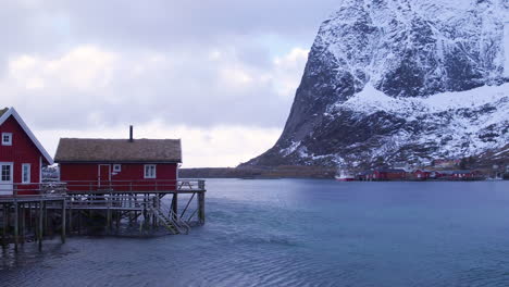 stunning cinematic tracking shot of houses on stilts in reine