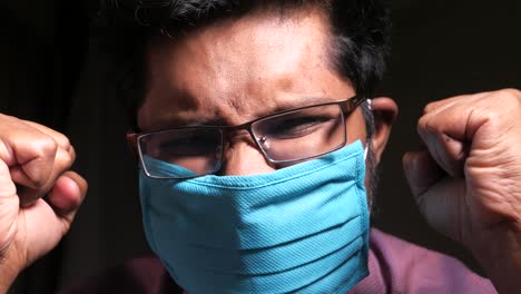 man wearing a mask, looking frustrated