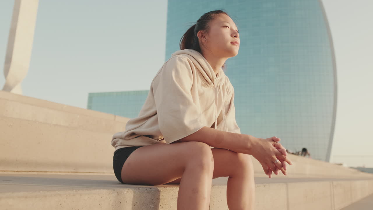 Asian woman sitting on stairs in the city