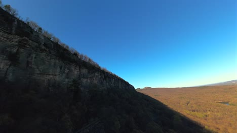 an aerial fpv drone shot in the mountains in upstate ny on a sunny day