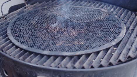 lit charcoal covered with grill