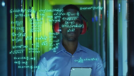 animation of mathematical equations over african american male worker in server room