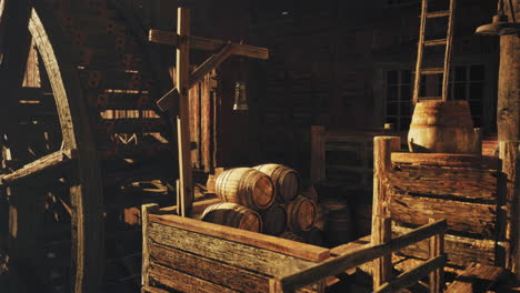 old wooden mill with water wheel and barrels