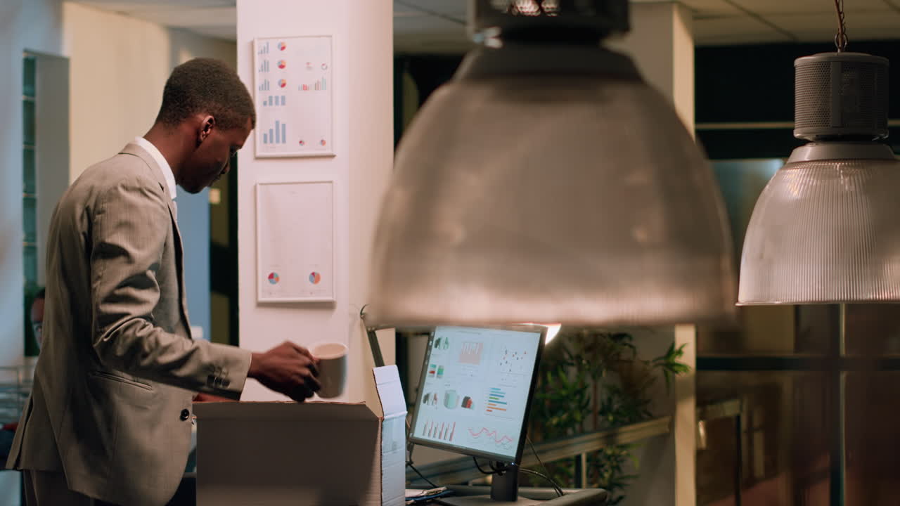Businessman packing belongings in office
