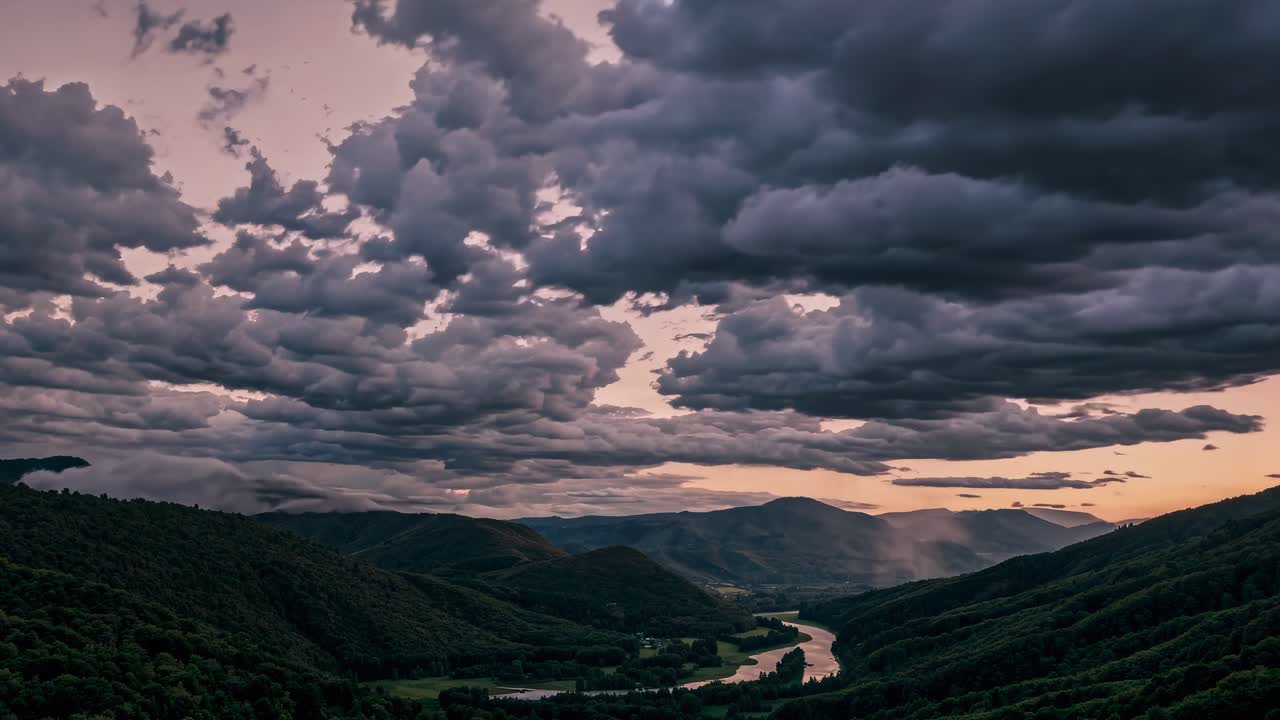 Aerial video captures dramatic clouds over lush valleys at sunset, highlighting the contrast between