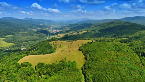 lush green hills and valleys. lush green hills and valleys stretch across the landscape under a bright blue sky filled with fluffy clouds