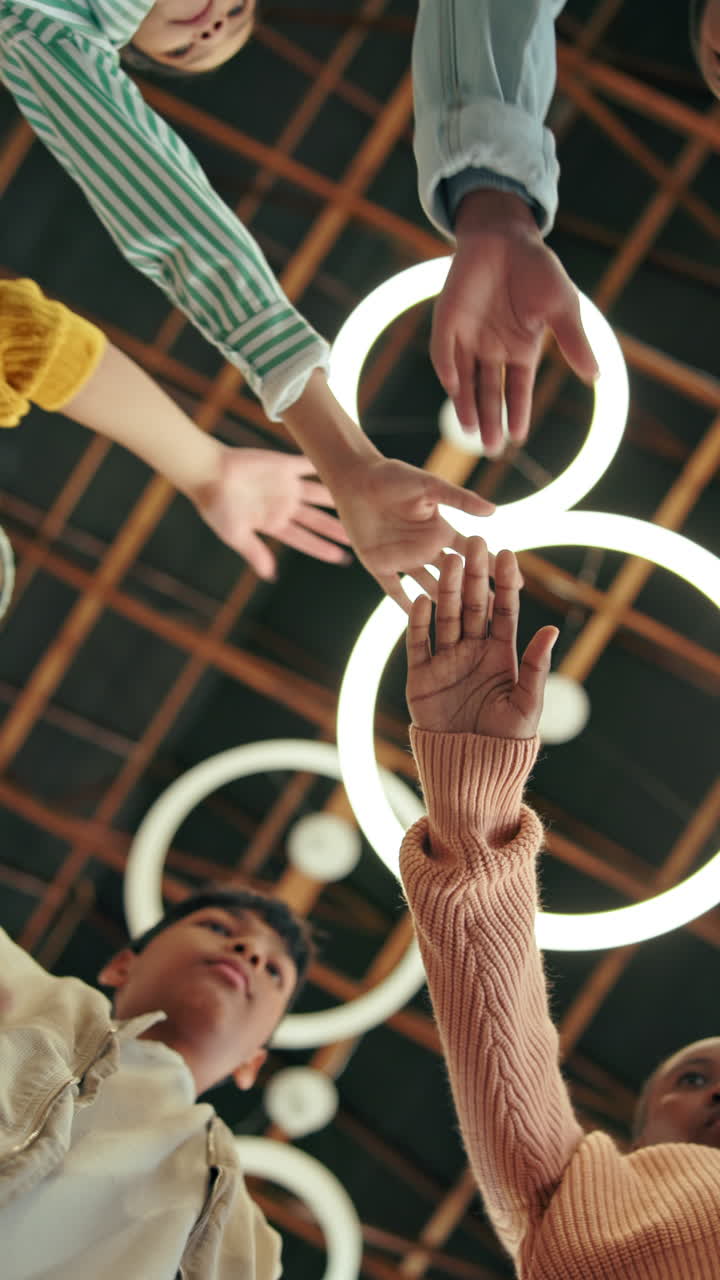 Diverse Group of People Stacking Hands in a Symbol of Unity and Teamwork