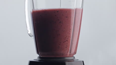 vitamin cocktail blending mixer super slow motion close up. fruit berry blend.