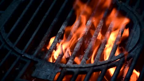 outdoor grill bars closeup showing flames and smoke from burning charcoal with copy space