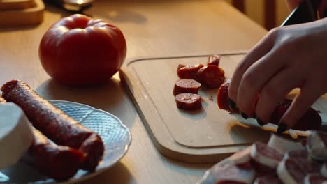 slicing sausage in a cozy kitchen, delicious flavors in the air, evening dinner prep at home