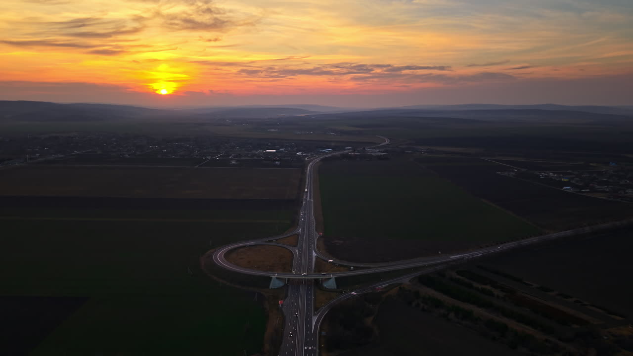 Aerial drone view of cars driving on the highway in Moldova at sunset