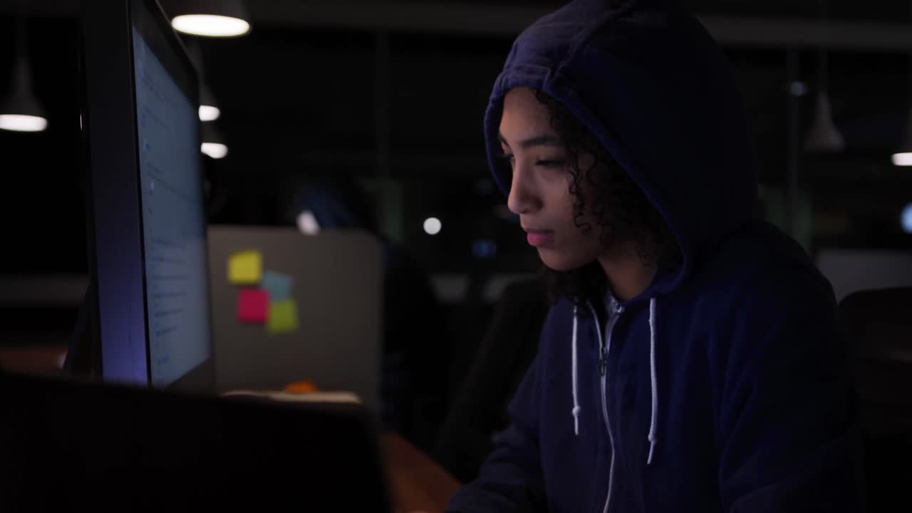 Businesswoman working in a modern office by night