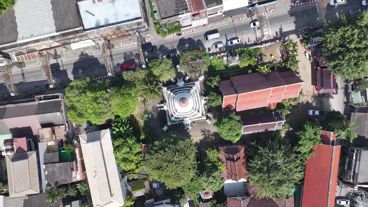 Cinematic look down to white stupa of Buddhist Temple in Chiang Mai city, Thailand