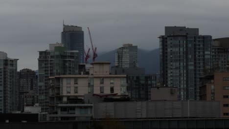 crane working in vancouver downtown timelapse on a cloudy rainy day