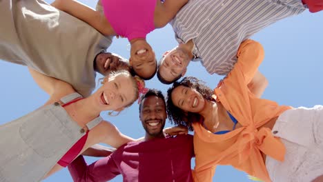 portrait of happy diverse group of friends embracing in circle