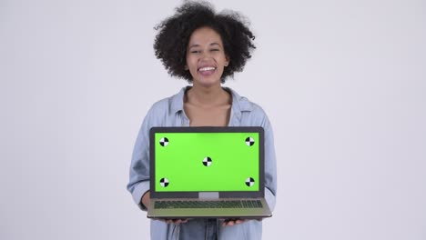 happy young beautiful african woman showing laptop