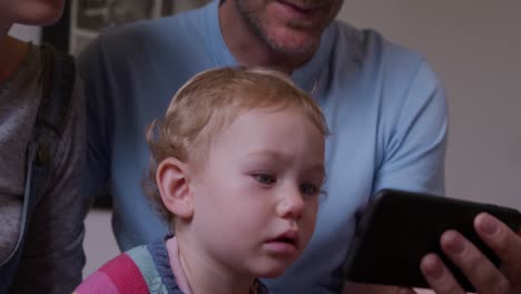close up view of baby looking at smartphone