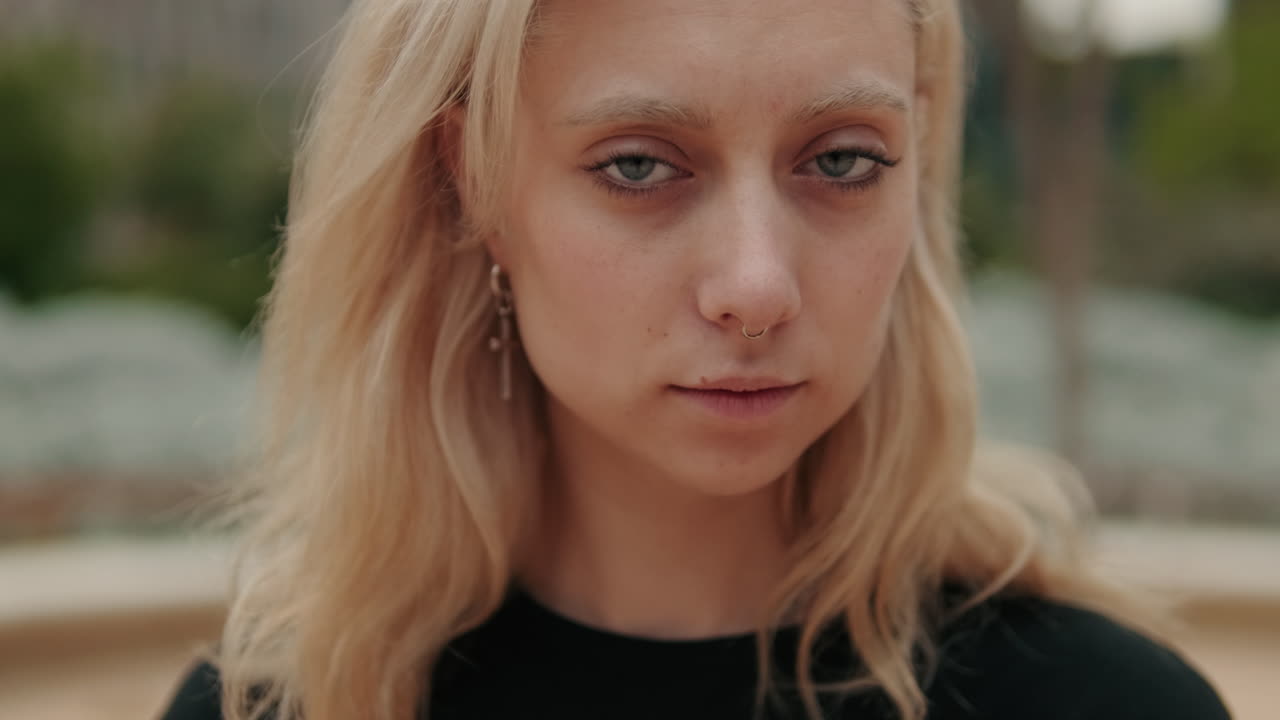 Close-up Portrait of Young Blonde Woman Looking at Camera