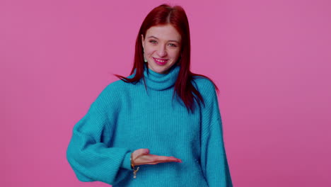 cheerful girl in blue sweater looking at camera doing phone gesture like says hey you call me back