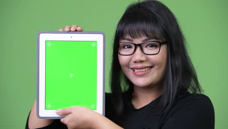 beautiful asian businesswoman showing digital tablet