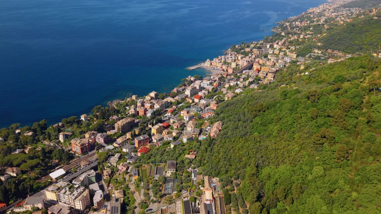 Orbita aerea con drone della costa ligure con città di mare e mare Mediterraneo blu, stile di vita costiero e paesaggio suggestivo.