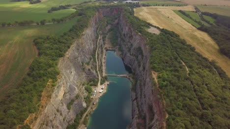 aerial drone footage captures huge cliffs and river nestled within vast green landscape in england, uk, highlighting the dramatic natural beauty and lush agricultural farms