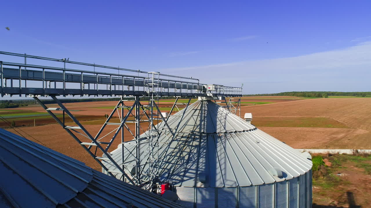 Aerial view. Metal grain elevator in agricultural zone. Grain warehouse