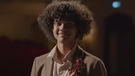 portrait of young african american violinist on stage