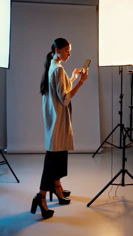 fashion model using smartphone in studio